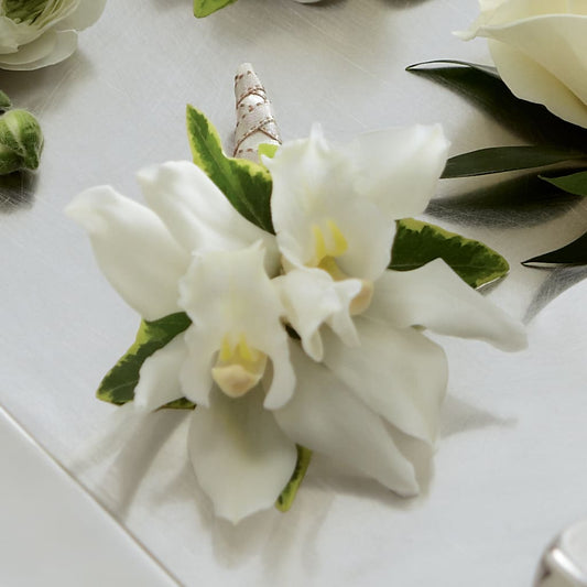 White Mini Cymbidium Boutonniere –  Joyce Florist Of Dallas Inc, Dallas TX